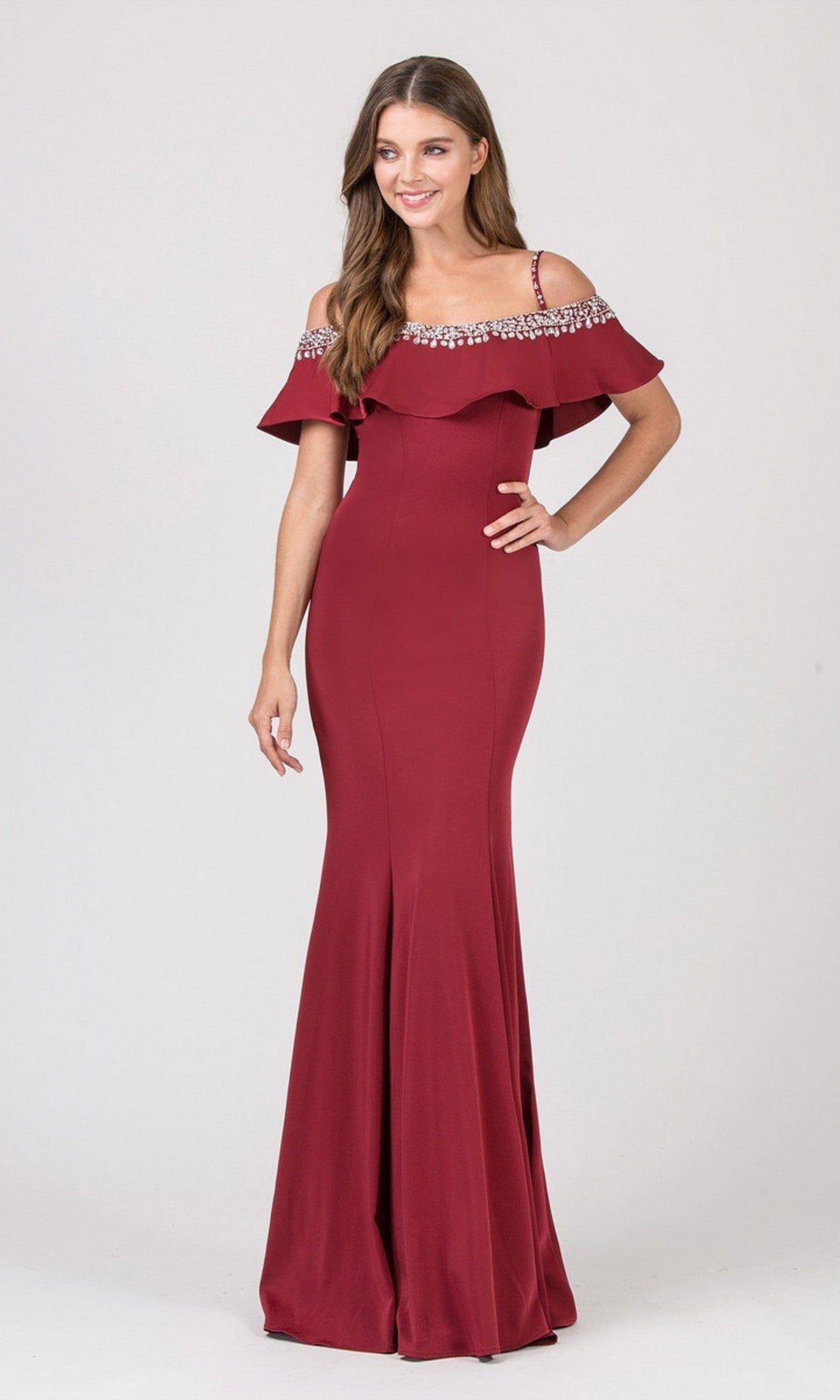 A woman wears the Eureka 7333 long prom dress in burgundy, featuring an off-the-shoulder design with ruffle detailing and rhinestone accents on the neckline, against a plain light background.